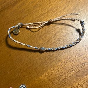 Braided pura vida bracelet with gold bead in the middle